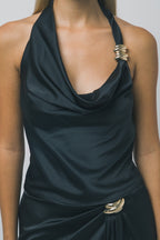 Close-up of a woman wearing a silky black halter top with gold hardware accents, part of a women's clothing outfit.