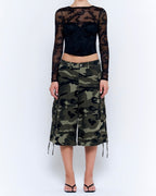 Woman wearing camouflage wide leg cargo culotte pants with drawstring hems and a black lace top