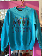 Blue vintage sweatshirt with cactus embroidery and bold Arizona lettering, women's casual fashion apparel.