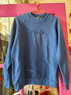 Navy blue vintage sweatshirt with embroidered bold lettering, casual women's clothing piece on display hanger.