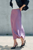 Mauve satin midi skirt styled with black heels and a dark jacket