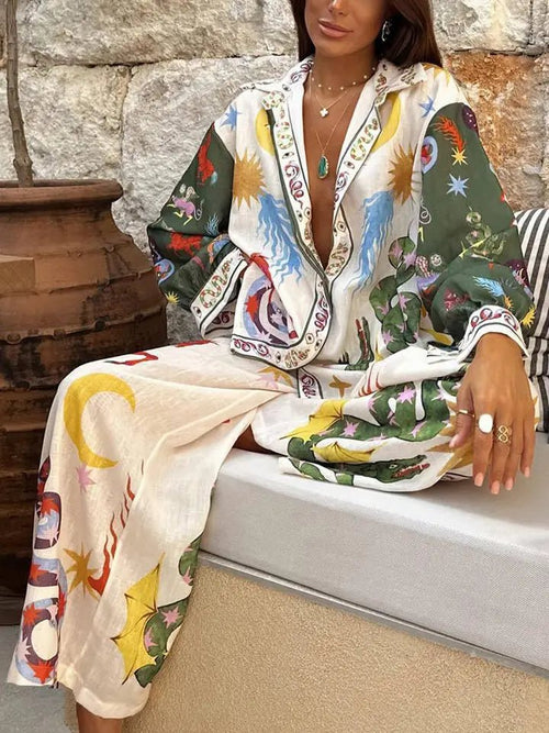 Woman wearing loose, colorful abstract printed pants and matching long-sleeve shirt in relaxed pose