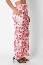 Women's floral print wide-leg pants with drawstring waist and pockets styled with black heeled sandals
