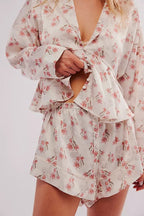 Close-up of a woman wearing floral lightweight sleepwear set with long sleeves and relaxed shorts for women's clothing.
