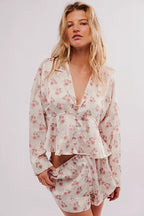 Woman wearing a relaxed fit floral long-sleeve button-down top and matching shorts sleepwear set