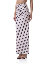 Women’s clothing long ruched skirt with large black polka dots on a light pink background