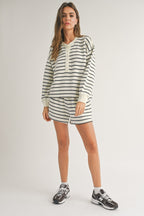 Woman wearing casual long-sleeve striped top and matching shorts, styled with athletic sneakers in women's clothing.