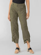 Women’s olive green cargo pants with multiple pockets and ankle strap detailing, styled with black sandals.
