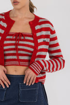 Woman wearing red and gray striped crop tube top with matching cardigan and denim skirt in women's clothing style.
