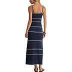 Woman wearing a navy blue striped maxi dress with spaghetti straps, shown from the back in women's clothing.