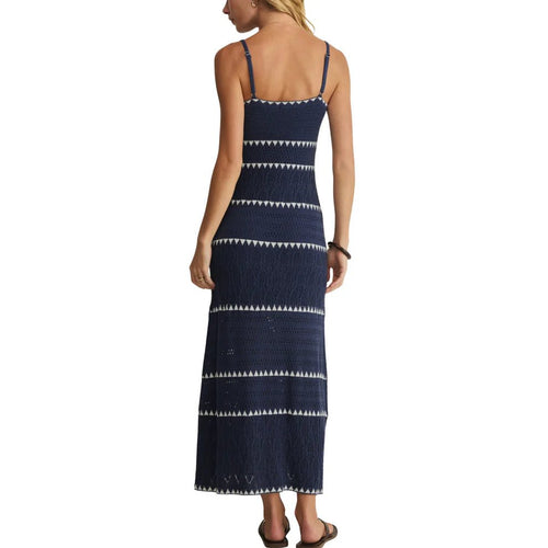 Woman wearing a navy blue striped maxi dress with spaghetti straps, shown from the back in women's clothing.