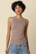 Woman wearing a taupe ribbed fitted tank top with jeans