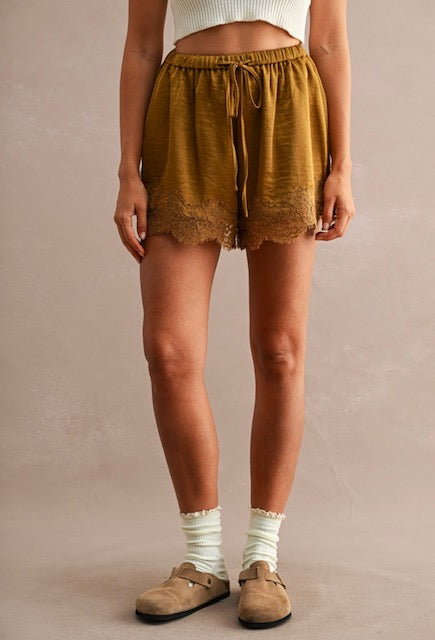 Women’s lace-trimmed shorts with adjustable drawstring and elastic waistband in a relaxed fit style