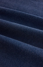 Close-up of dark blue soft jersey fabric with a denim-like texture for women's clothing.
