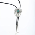 Black bolo tie with silver and turquoise eagle-shaped slide featuring engraved patterns and conical metal tips