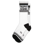White socks with black accents and "TROPHY HUSBAND" text, suitable for women's casual clothing.