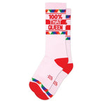 Pink athletic socks with red toes and heels, featuring colorful geometric patterns and bold text design.