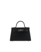 Black structured women's handbag with top handle and gold-tone clasp detailing on front