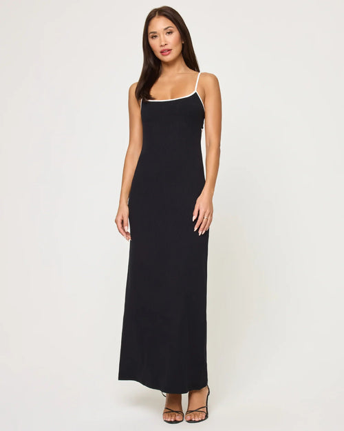 Woman wearing a form-fitting black ankle-length dress with thin straps and a square neckline in women's clothing.