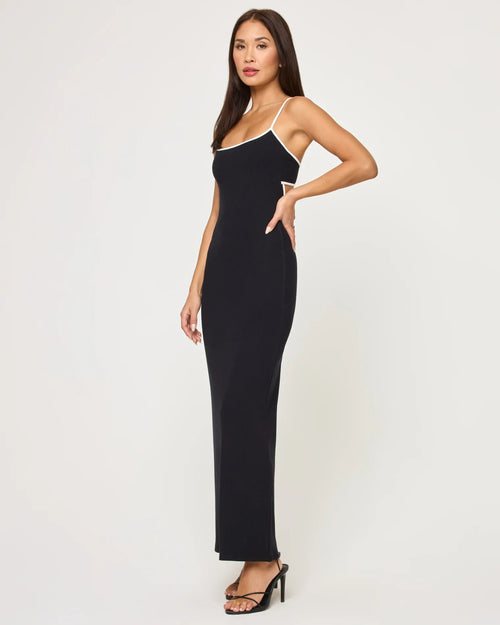 Woman wearing a sleek black ankle-length dress with thin straps and a back cut-out detail in women's clothing.