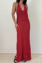 Woman wearing a red knit halter dress with plunging neckline and side slits in women's clothing fashion
