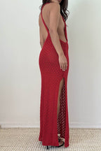 Woman wearing a sleeveless red knit maxi dress with side slit and open back in women's clothing fashion style