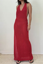 Woman wearing a sleeveless red knit maxi dress with a plunging neckline and open back in women's clothing style