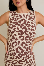Close-up of a woman wearing a sleeveless knit dress with a brown leopard print pattern in women's clothing