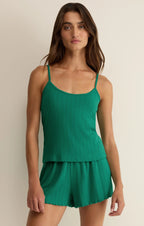Woman wearing a green ribbed cami and matching shorts set, styled for casual women's clothing.