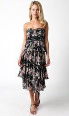 Woman wearing strapless floral midi dress with layered tiers in black and pink tones for women's clothing.