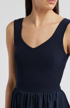 Close-up of a sleeveless women's dress with ribbed knit bodice and cotton skirt in dark navy color
