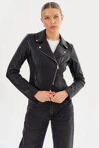 Woman wearing fitted black leather moto jacket with front diagonal zipper and snap collar in casual outfit