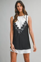Woman wearing a black lace tank overlay over a white mini dress in women's fashion clothing.