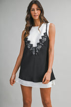woman wearing black lace overlay tank dress layered over white mini dress in women's clothing style