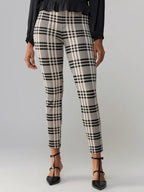 Women’s fitted leggings in black and beige plaid pattern paired with black heels and blouse