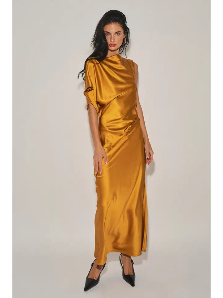 Woman wearing gold satin maxi dress with asymmetrical neckline and single cap sleeve in a studio setting