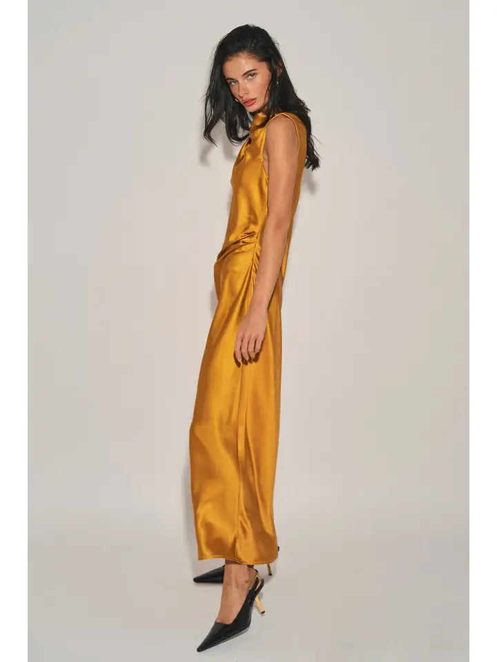 Woman wearing gold satin maxi dress with asymmetrical neckline and single cap sleeve in side profile pose