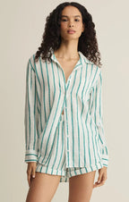 Woman wearing a casual white and teal striped shirt and matching shorts in a relaxed outfit for women’s clothing.