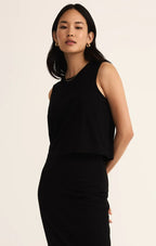Woman wearing a sleeveless black cotton jersey tank top with a relaxed fit and crew neckline in women's clothing.