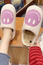 Cozy fuzzy slippers in cream with purple happy face design, perfect for women's casual indoor wear.