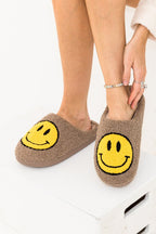 Women’s cozy sherpa slippers in beige with bright yellow happy smiley face design on top