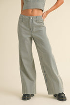 Woman wearing high-waisted wide-leg striped pants paired with a matching cropped top and black shoes.