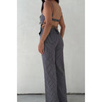 Woman wearing black and white striped wide-leg jeans with a fitted back and high waist from women's clothing collection