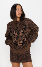Woman wearing a brown tiger print sweater with long sleeves and a soft knit texture