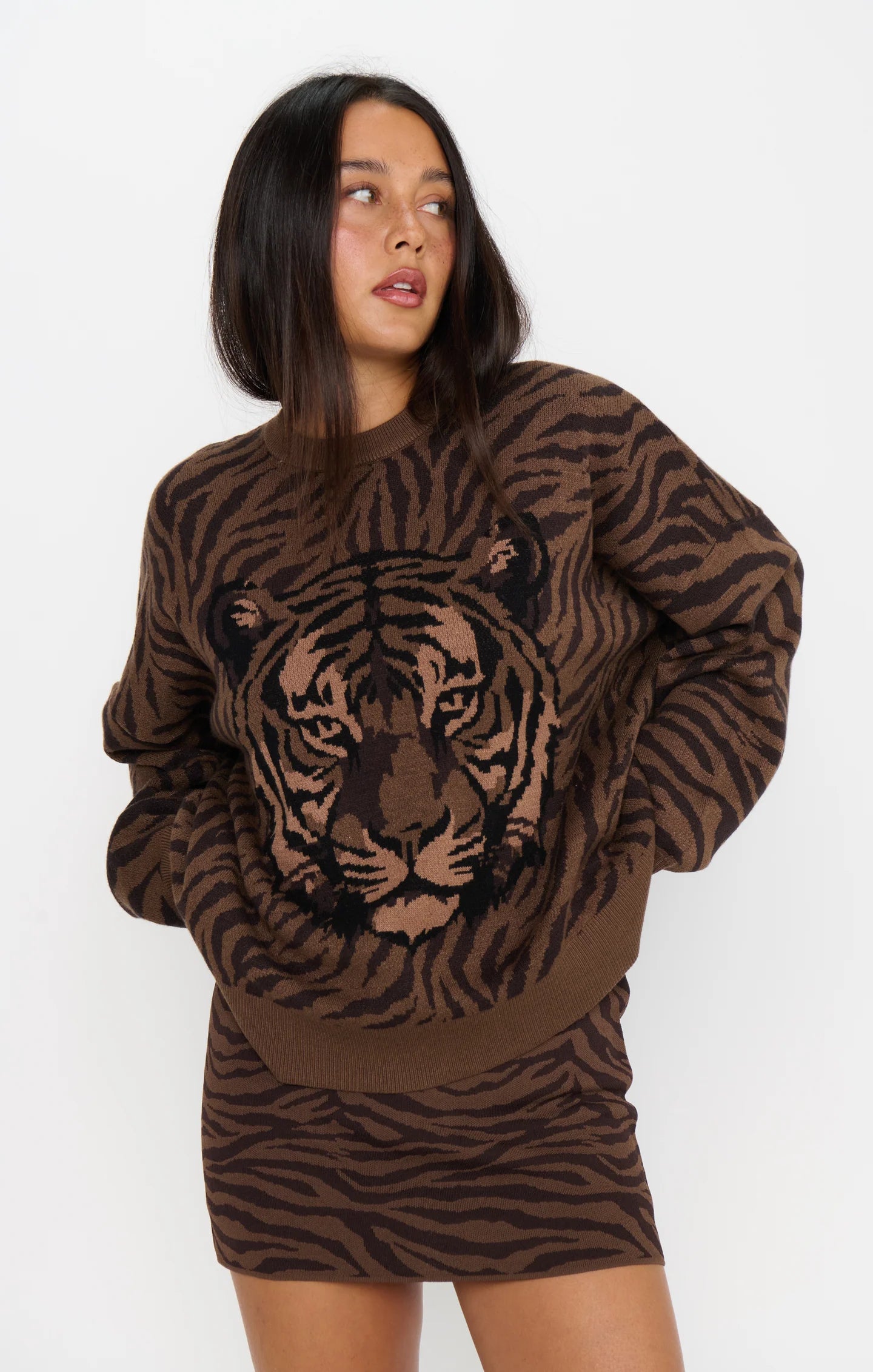 Woman wearing a brown tiger print sweater with long sleeves and a soft knit texture