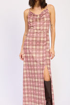 Woman wearing a pink and beige plaid maxi dress with a side slit and thin shoulder straps in women's clothing.