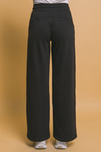 Back view of black wide-leg sweatpants designed for comfortable everyday women's clothing.