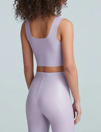 Woman wearing light purple seamless crop top and matching high-waisted leggings in women's clothing.
