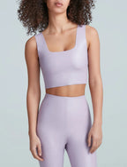 Woman wearing a light purple squareneck crop top and matching high-waisted leggings in women's clothing style.