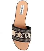 Slip-on flat sandal with fabric upper and bold stitched lettering on the top strap for women's casual wear